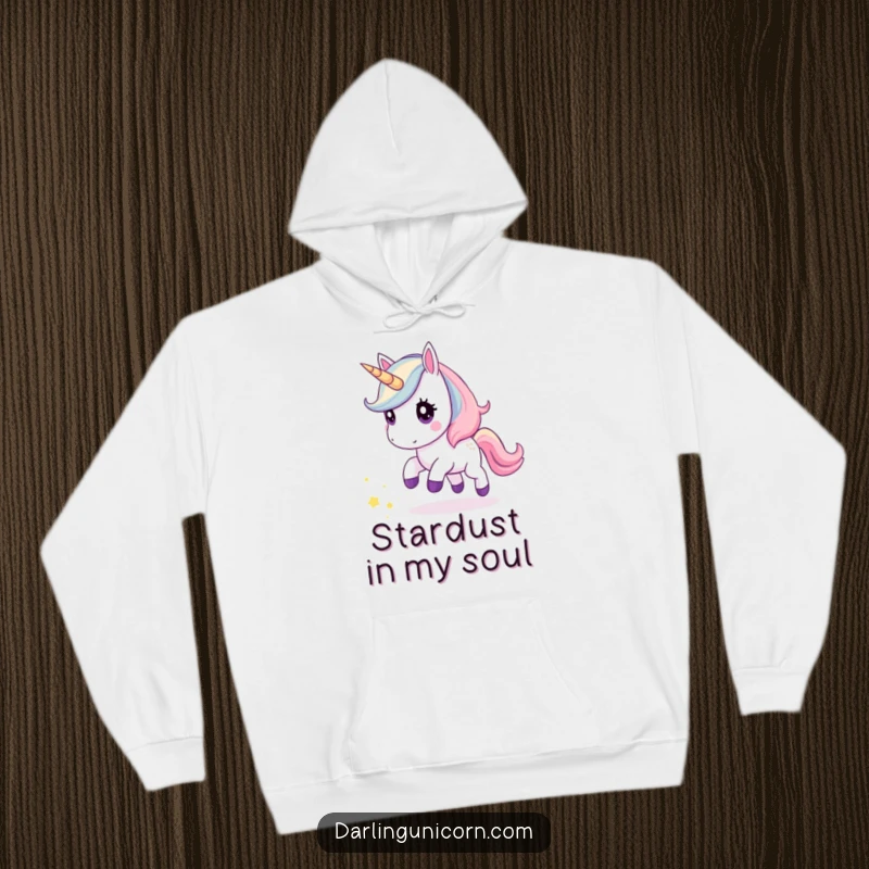 Funny kawaii unicorn hoodie depicting a cute unicorn curiously pursuing a glittering trail of stardust, ideal for cozy, magical moments.