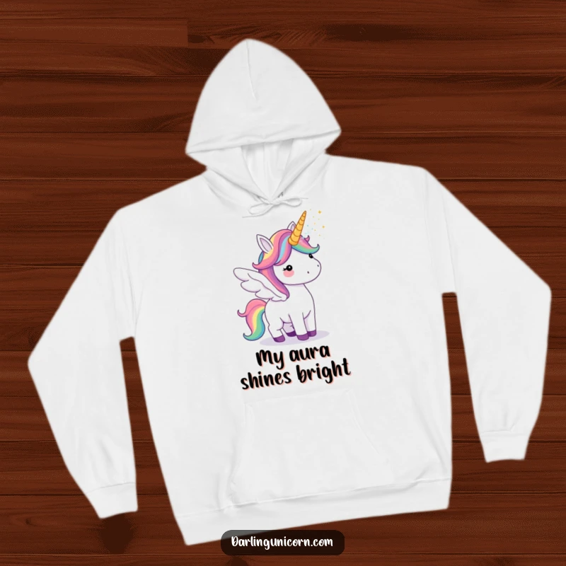 Funny hoodie showcasing a unicorn with colorful rainbow wings, cheerfully blowing magical glitter from its horn.