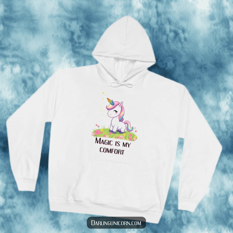 Funny hoodie illustrating a happy unicorn with a rainbow horn showering stardust upon a tranquil meadow, creating a whimsical and magical feel.