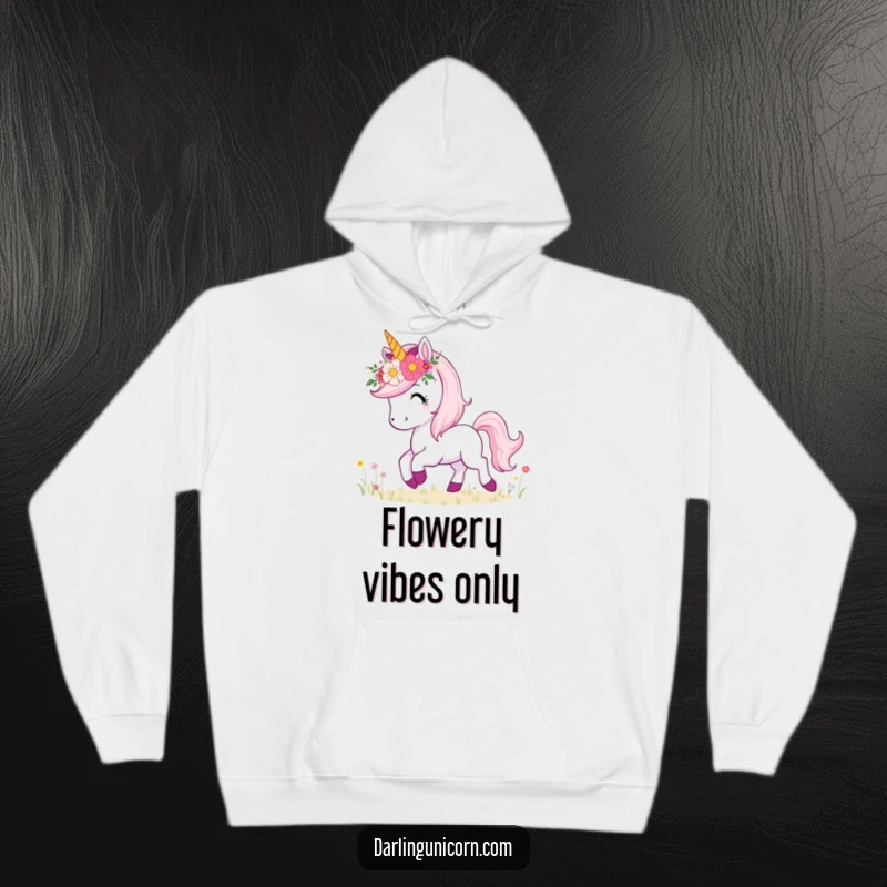 Funny hoodie featuring a unicorn with a lovely flower crown, joyfully prancing through a picturesque meadow landscape.