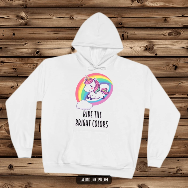 Funny hoodie depicting a playful unicorn sliding down a vibrant rainbow with a cheerful whoop, perfect for cozy and fun moments.